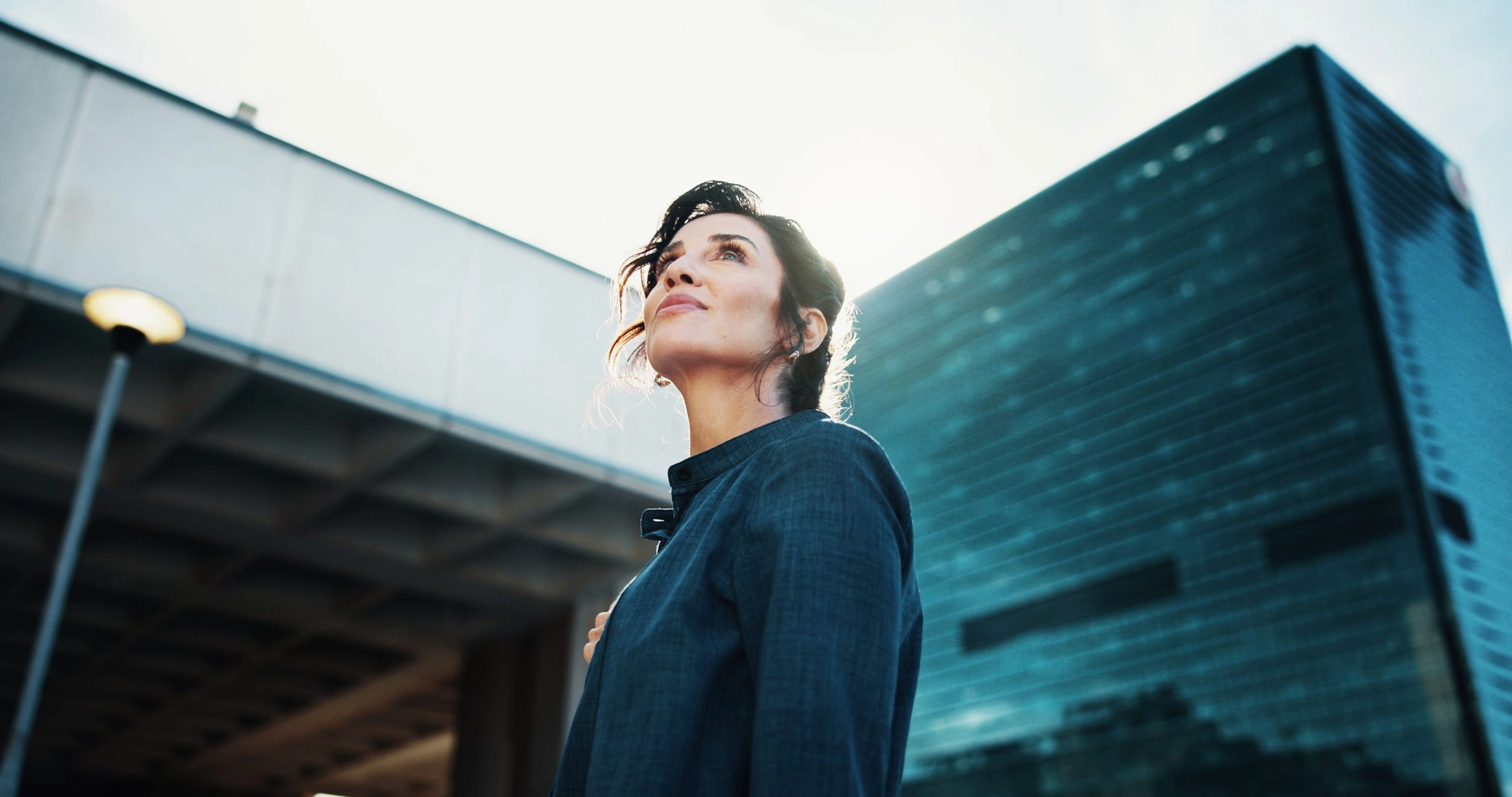 Morning, inspiration and business woman in city with idea, brainstorming and career insights. Thinking, low angle and confident person for company future, urban development and job opportunity